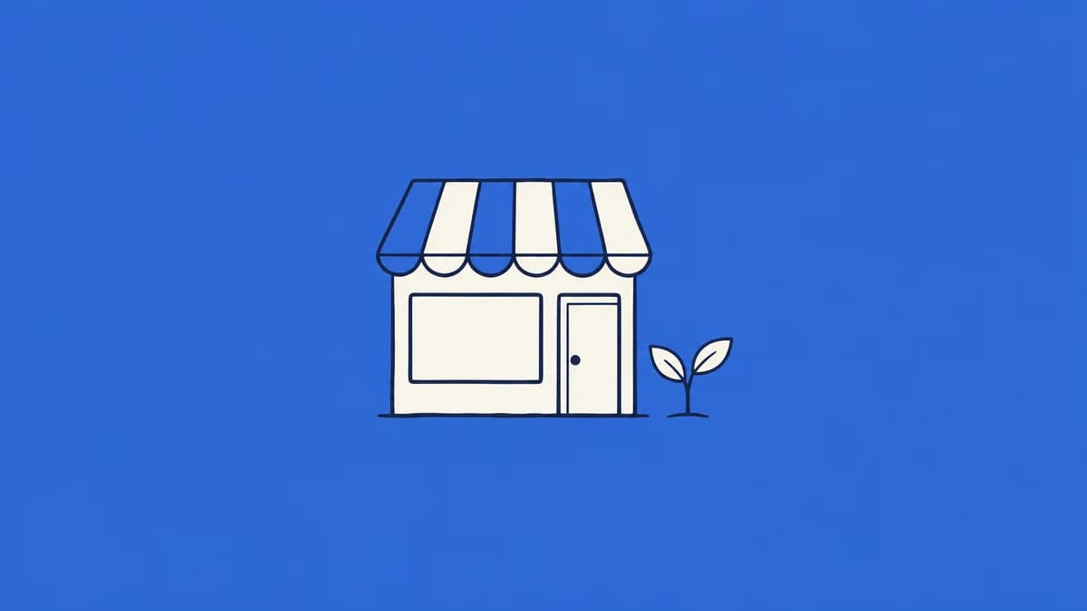 A small shopfront with a striped awning and seedling.